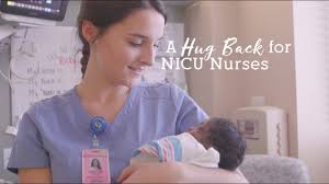 A NICU nurse holding a premature baby.